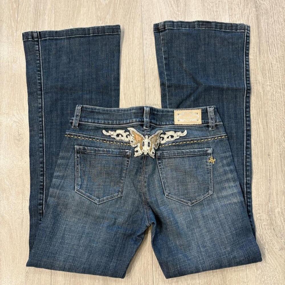 ET BOITE blue denim jeans with butterfly embroidery on the back.